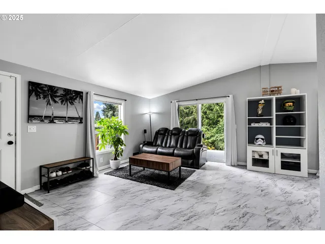 a living room with furniture windows and a flat screen tv