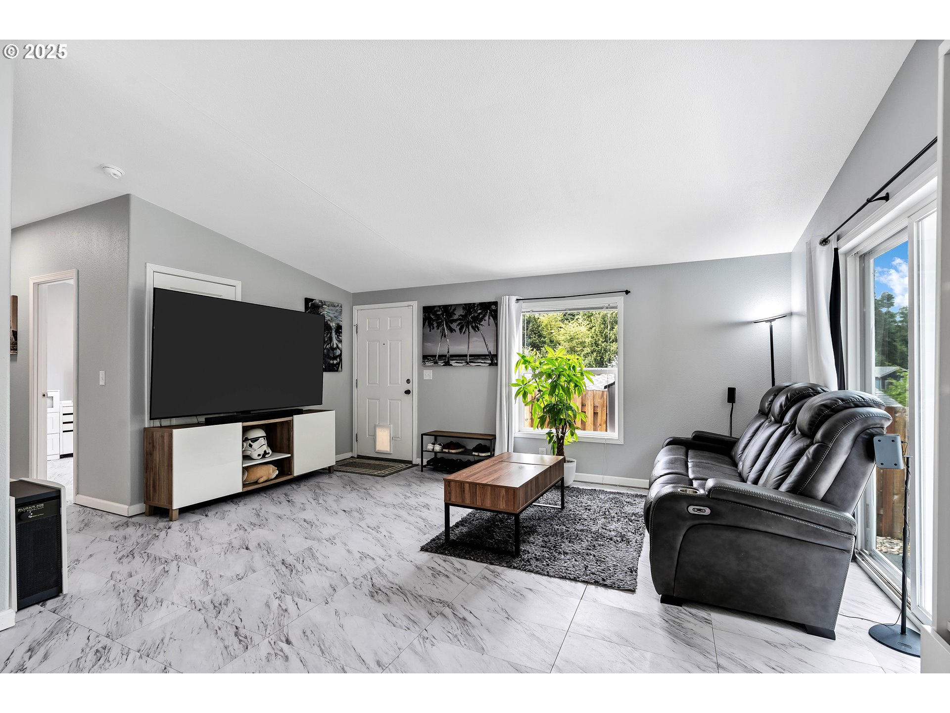 8750 Southeast 155th Avenue, Unit 28 Happy Valley, OR 97086 - Photo 7 of 28 a living room with furniture and a flat screen tv