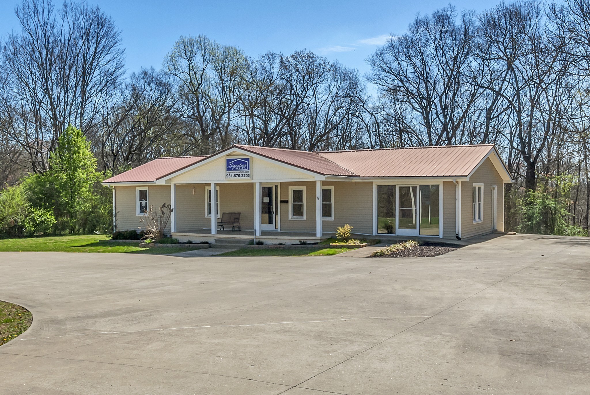 5652 Highway 100 Lyles, TN 37098 - Photo 1 of 21 a front view of a house with a yard and trees