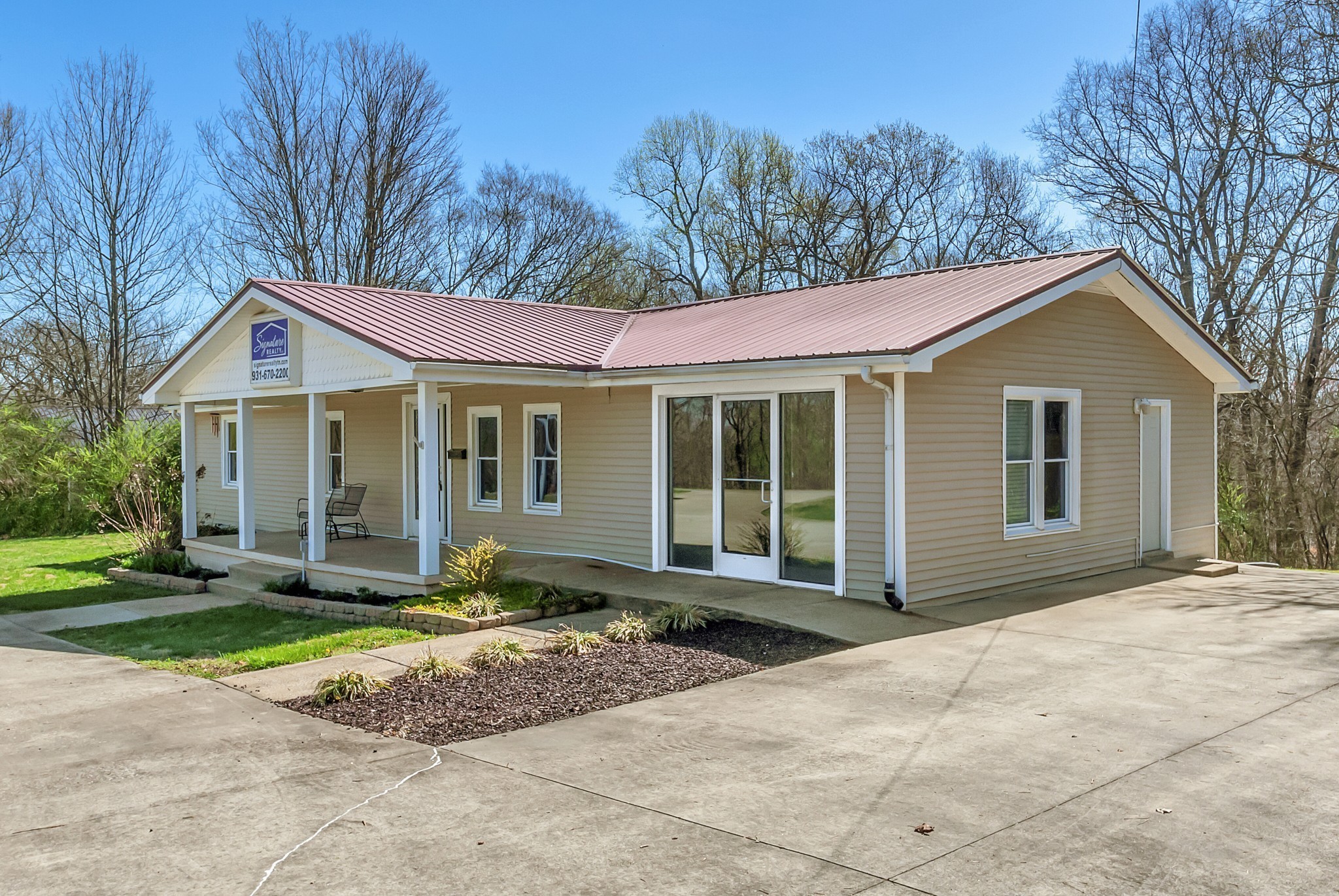 5652 Highway 100 Lyles, TN 37098 - Photo 4 of 21 a front view of a house with a yard and trees
