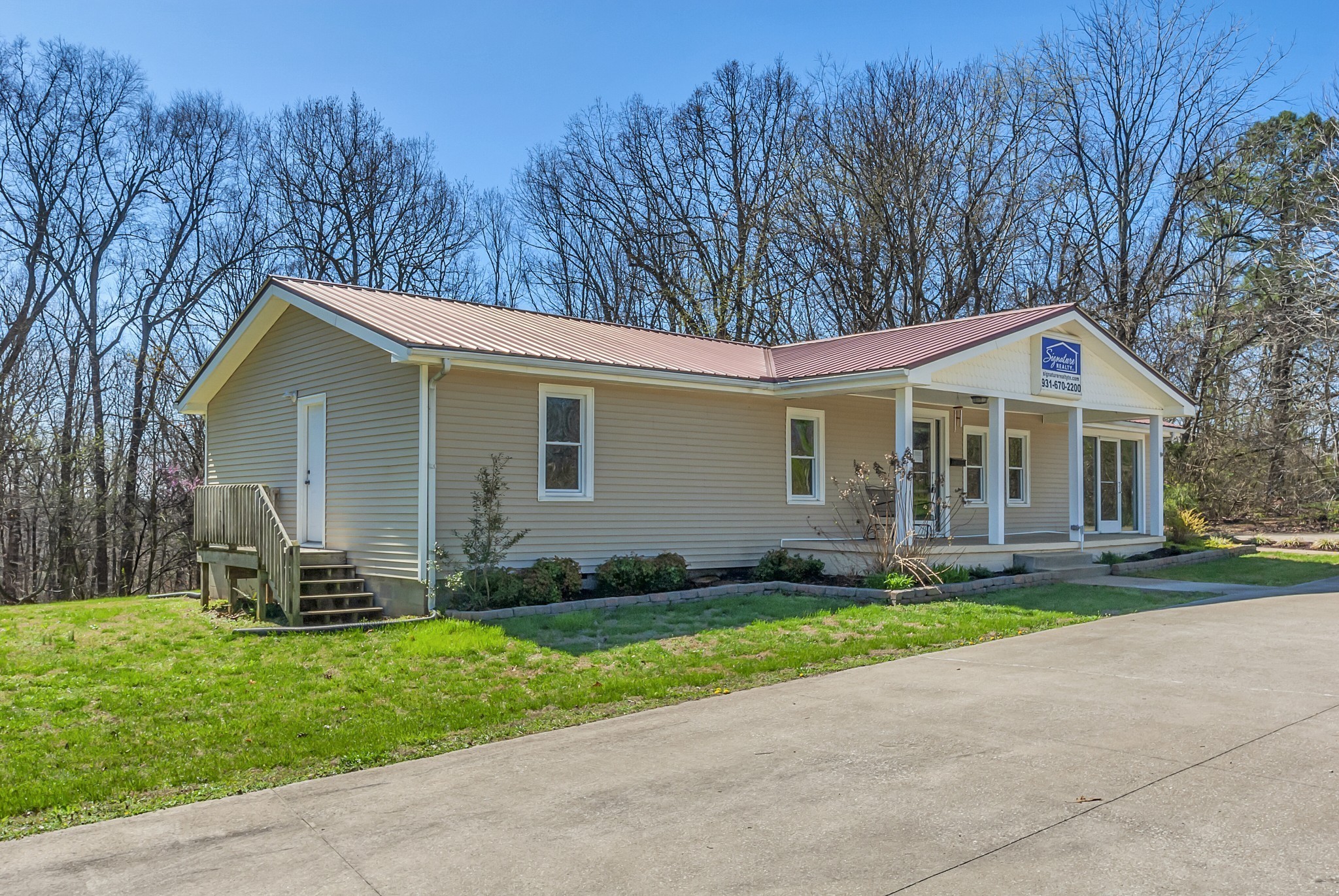5652 Highway 100 Lyles, TN 37098 - Photo 5 of 21 a front view of a house with a garden