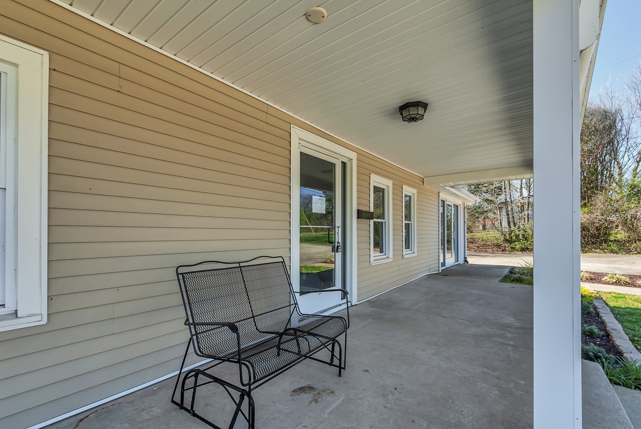 5652 Highway 100 Lyles, TN 37098 - Photo 7 of 21 a view of a porch with furniture and floor to ceiling window