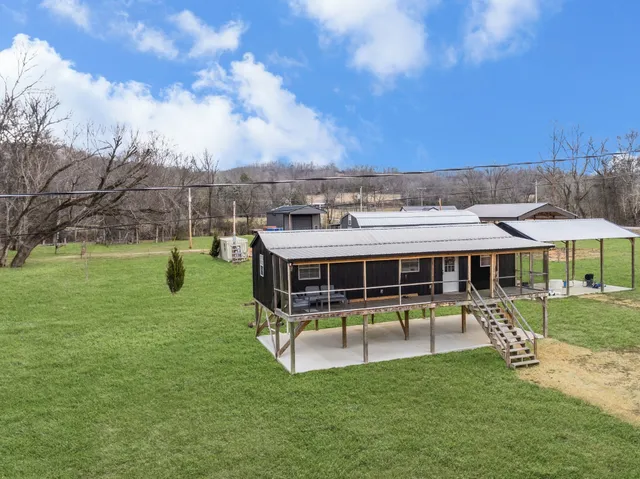 a view of a house with a backyard porch and sitting area