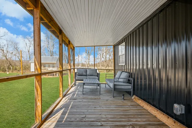 a balcony with chairs and wooden floor