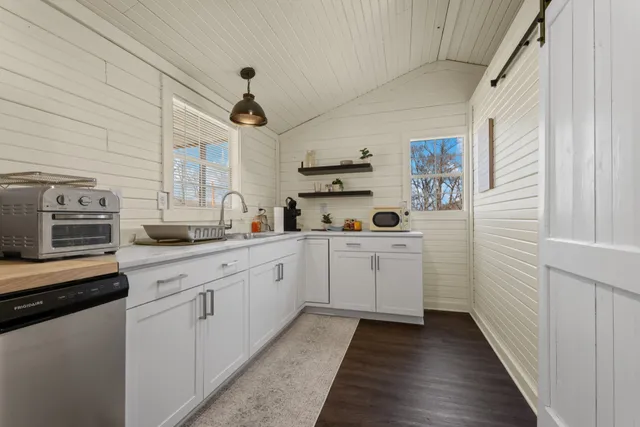 a kitchen with white cabinets and white appliances