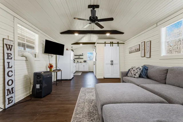 a living room with furniture and a flat screen tv