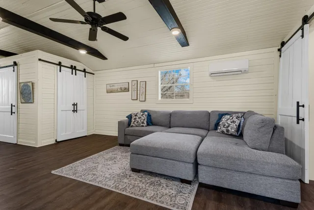 a living room with furniture and a wooden floor