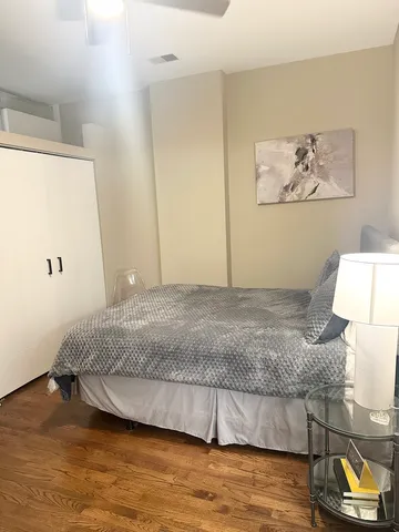 a bedroom with a bed and a wall painting