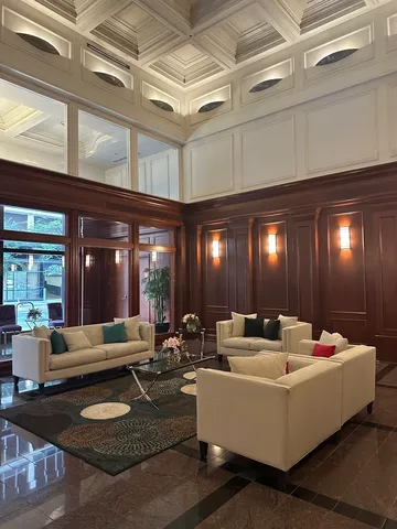 a living room with furniture and chandelier
