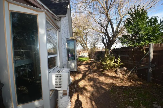 a view of a house with a yard and tree