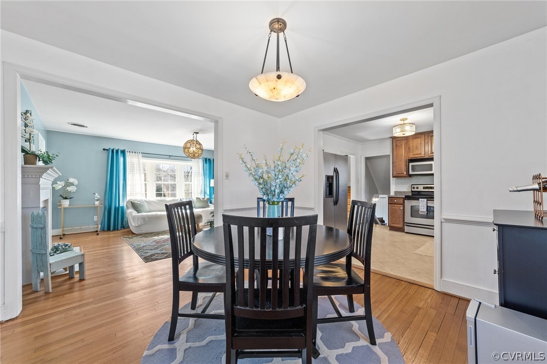8822 Chippenham Road Richmond, VA 23235 - Photo 12 of 37 a view of a dining room with furniture window and wooden floor