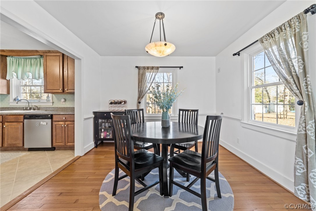 8822 Chippenham Road Richmond, VA 23235 - Photo 13 of 37 a dining room with furniture a chandelier and wooden floor