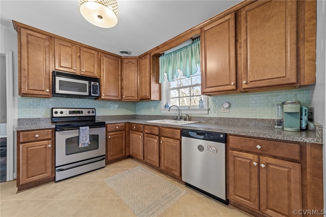 8822 Chippenham Road Richmond, VA 23235 - Photo 14 of 37 a kitchen with granite countertop cabinets stainless steel appliances and a sink