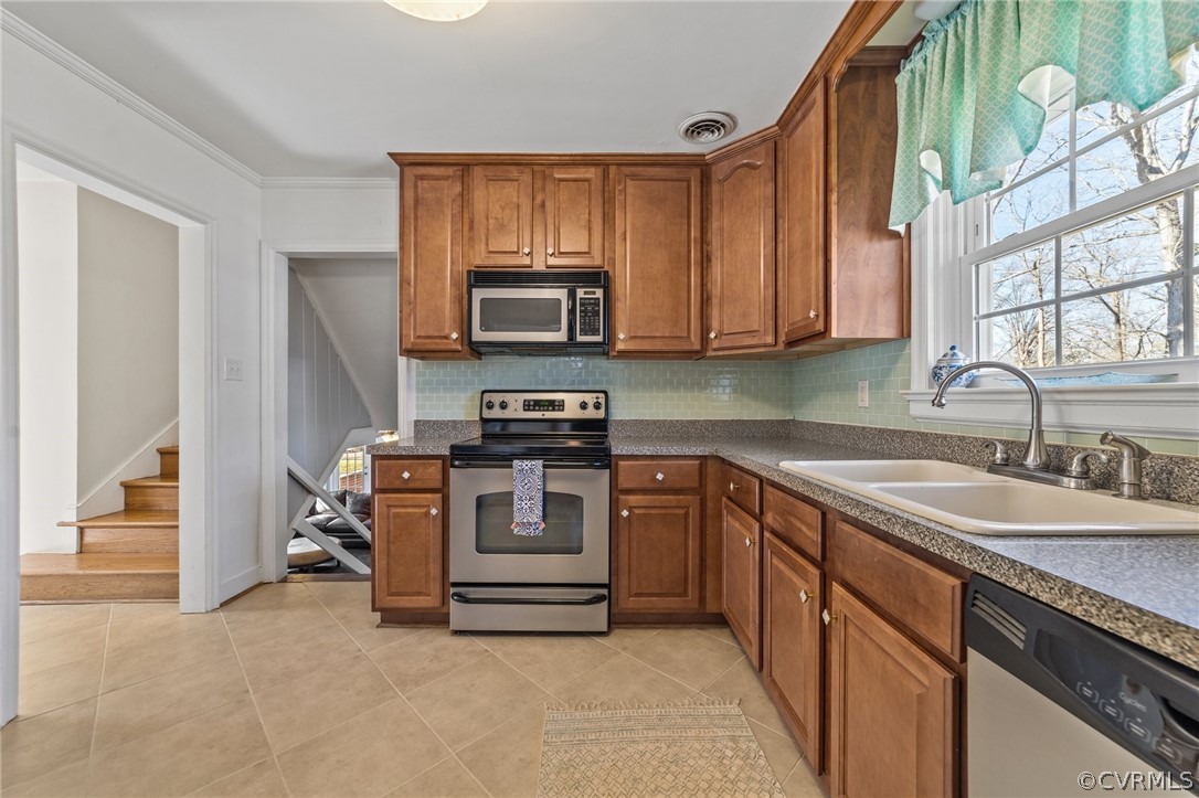 8822 Chippenham Road Richmond, VA 23235 - Photo 15 of 37 a kitchen with a sink stove and microwave