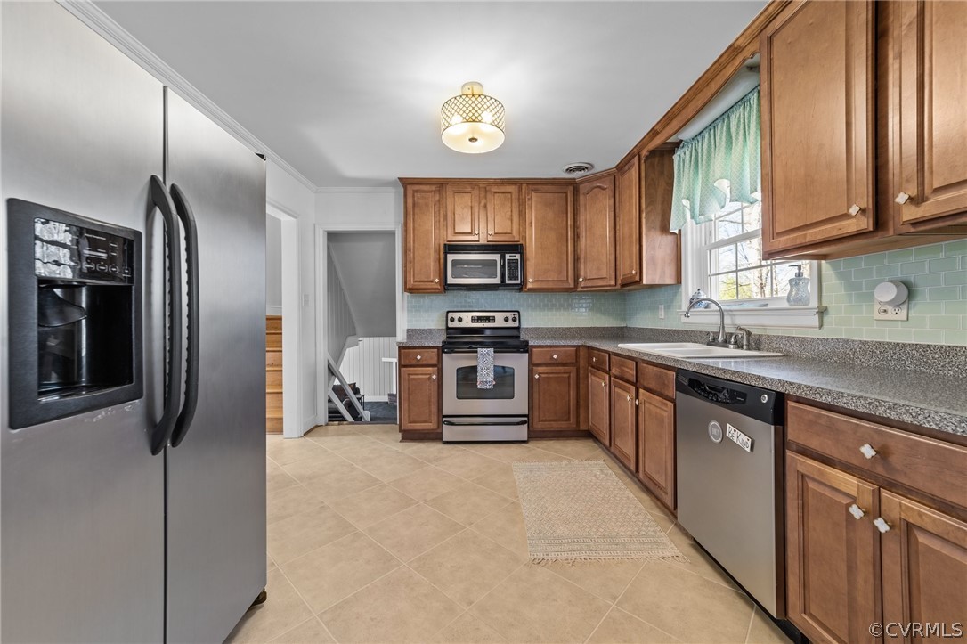8822 Chippenham Road Richmond, VA 23235 - Photo 16 of 37 a kitchen with stainless steel appliances granite countertop a stove a sink and a refrigerator