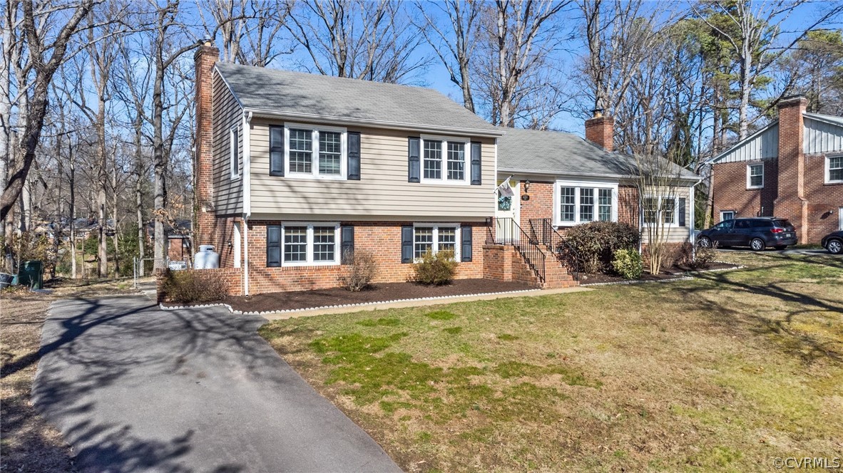 8822 Chippenham Road Richmond, VA 23235 - Photo 3 of 37 a front view of a house with a yard and trees
