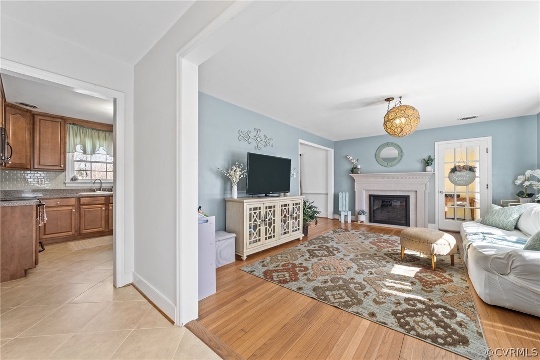 8822 Chippenham Road Richmond, VA 23235 - Photo 6 of 37 a living room with furniture a fireplace and a flat screen tv