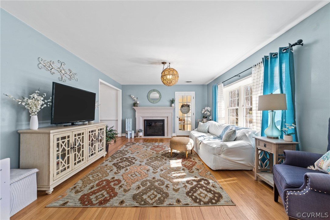 8822 Chippenham Road Richmond, VA 23235 - Photo 7 of 37 a living room with furniture a flat screen tv and a fireplace