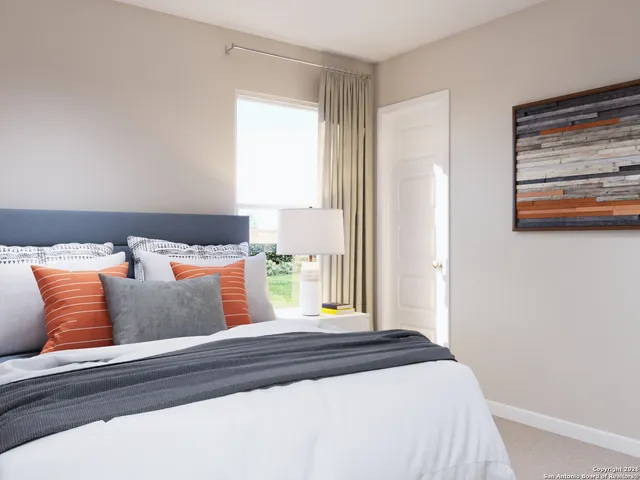 a bedroom with a bed and window