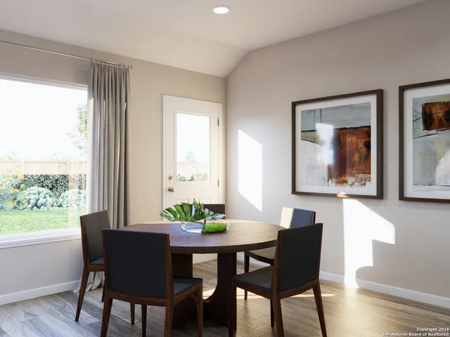 a dining room with furniture and window