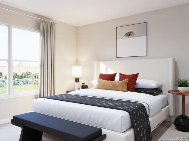 a bedroom with a bed and a window