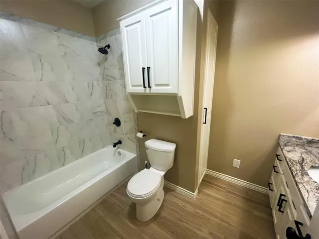 a kitchen with stainless steel appliances granite countertop a refrigerator a stove and a sink