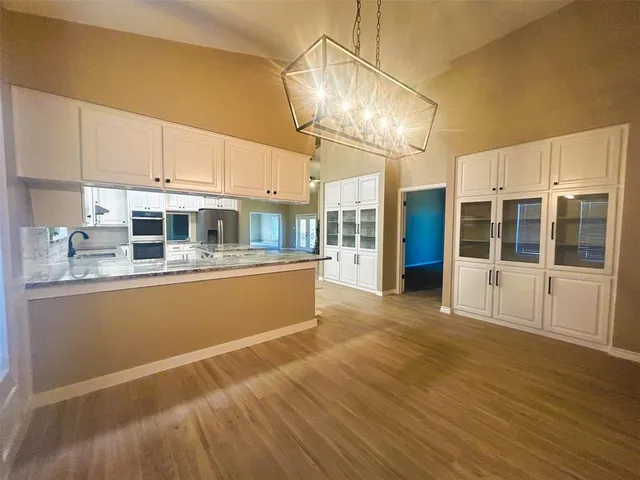 a view of a kitchen with a sink and cabinets