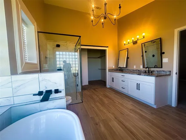 a spacious bathroom with a granite countertop sink a toilet and shower