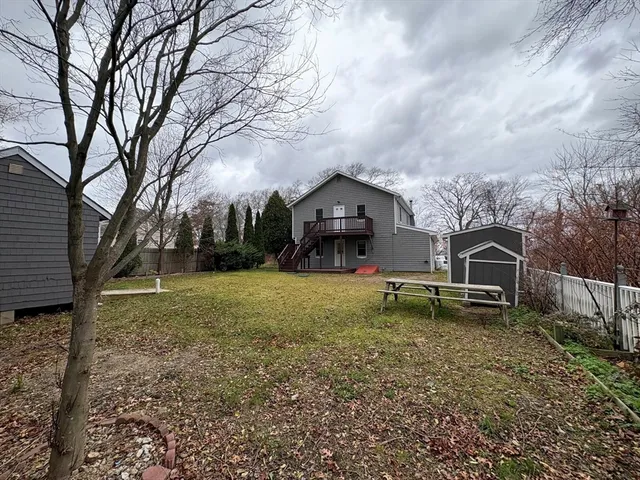 a backyard of a house with bicycles parked and swing