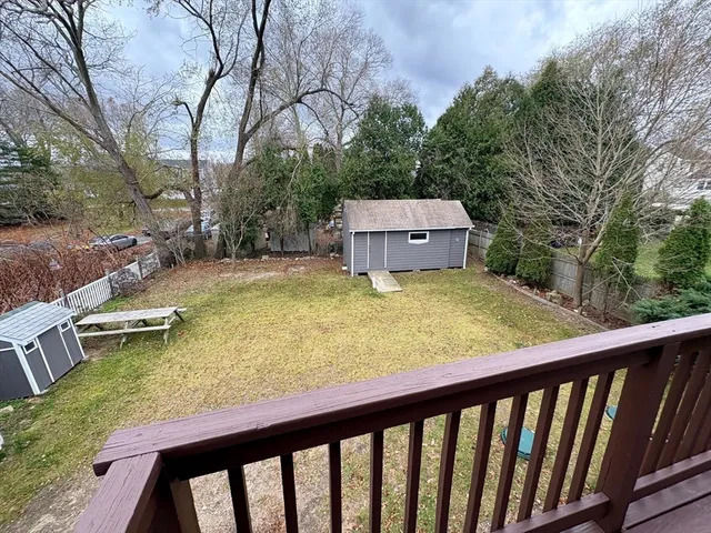 a view of a swimming pool with a patio and a yard