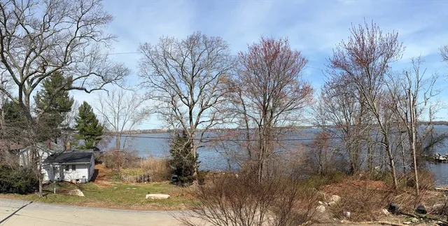 a large kitchen with stainless steel appliances granite countertop a large window and a sink