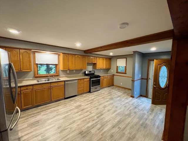 a kitchen with granite countertop a stove and a refrigerator