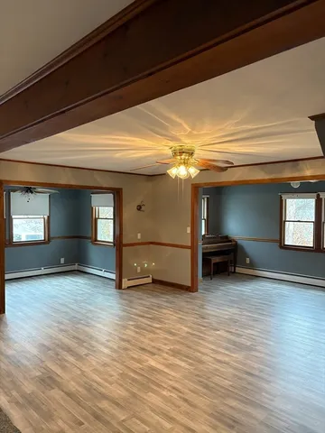 a view of a livingroom with furniture and a window