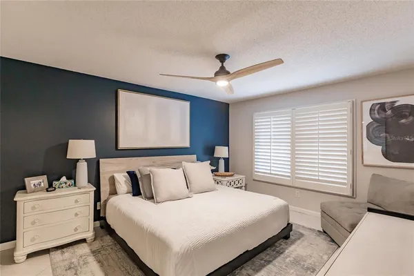 a bedroom with a large bed and a window
