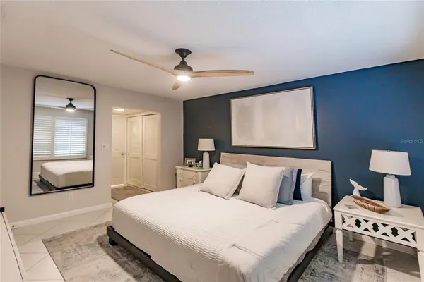 a bedroom with a bed and a tv