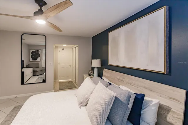 a bedroom with a bed and a large mirror