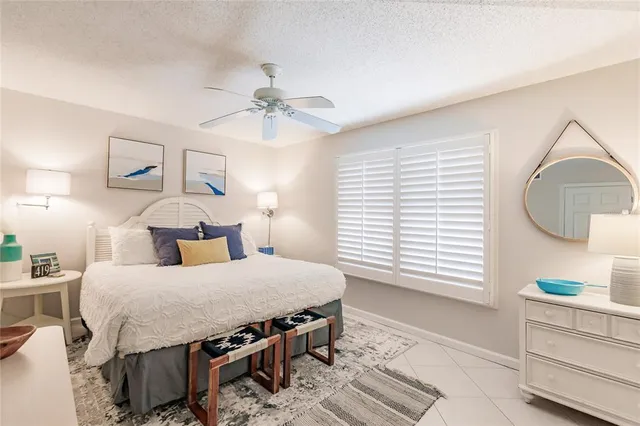 a bedroom with a bed a dresser and next to a window