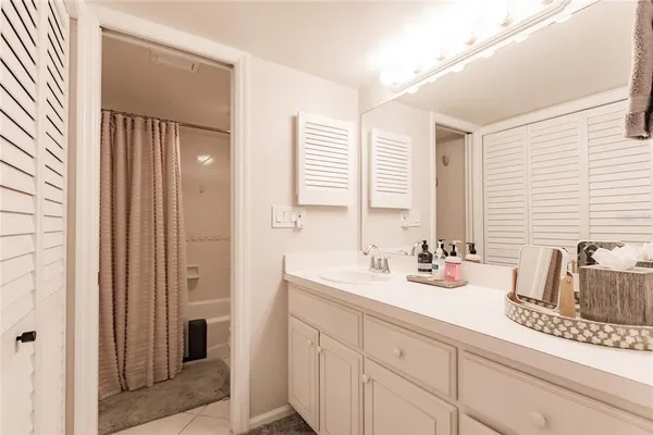 a bathroom with 2 sink tub and a mirror