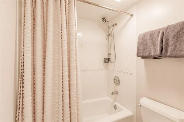 a bathroom with a bathtub and shower