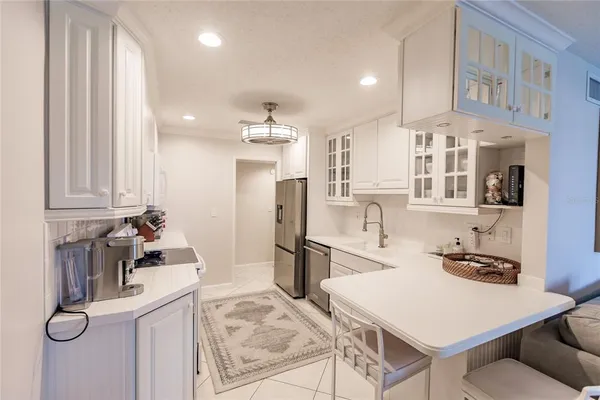 a kitchen with refrigerator and cabinets