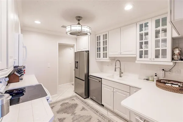 a kitchen with stainless steel appliances a sink stove and refrigerator