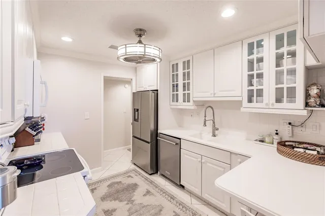 a kitchen with stainless steel appliances a sink stove and refrigerator