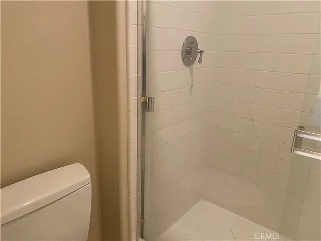 a bathroom with a shower and toilet