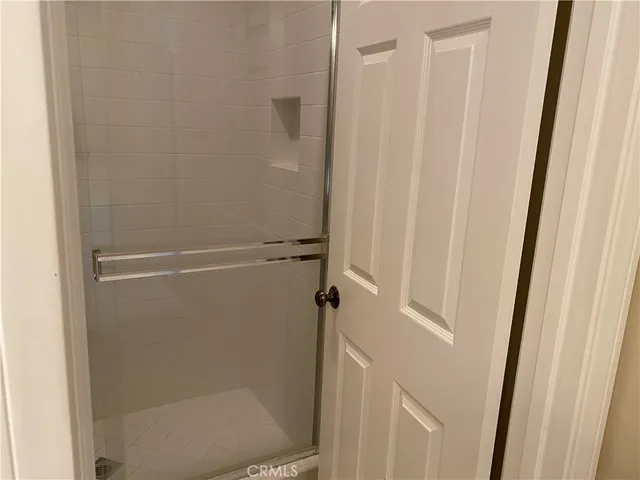 a bathroom with a glass shower door