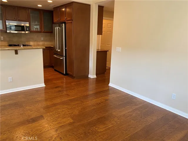 a kitchen with stainless steel appliances a refrigerator and a stove top oven