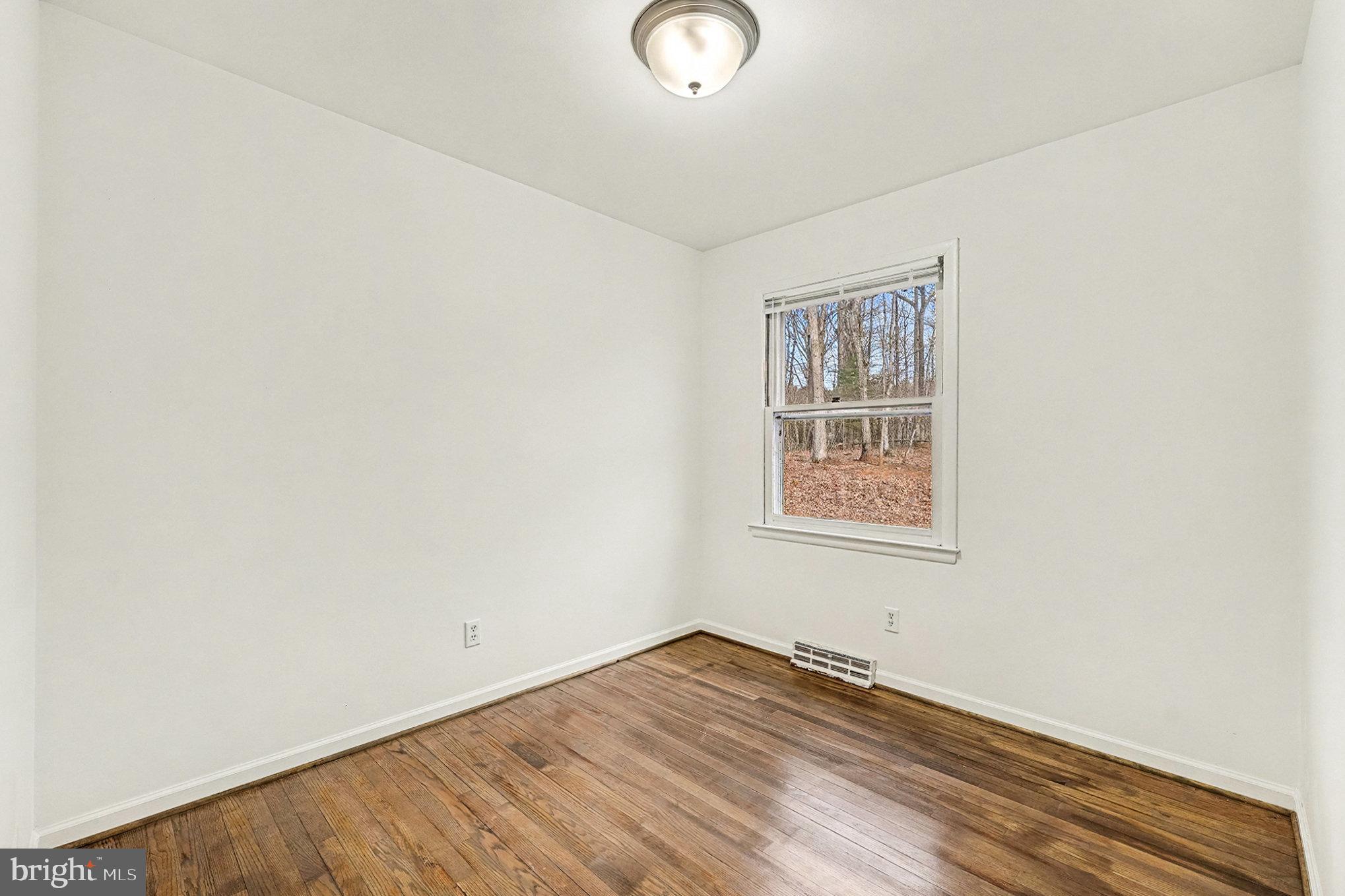 4127 Cabin Road Reva, VA 22735 - Photo 16 of 28 a view of an empty room with wooden floor and a window