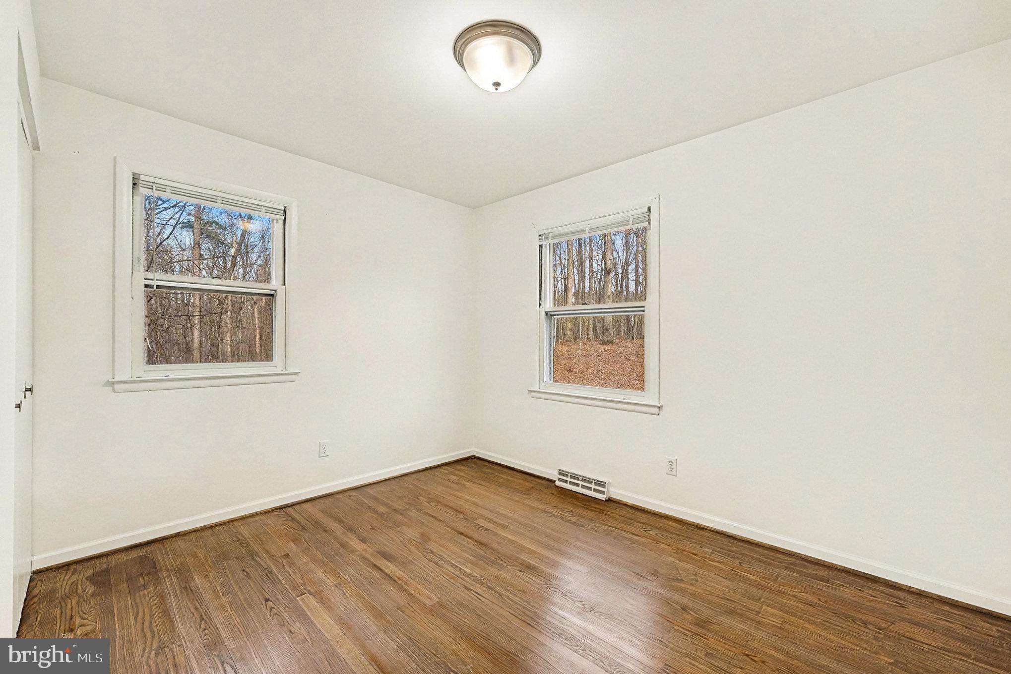 4127 Cabin Road Reva, VA 22735 - Photo 17 of 28 an empty room with wooden floor and windows