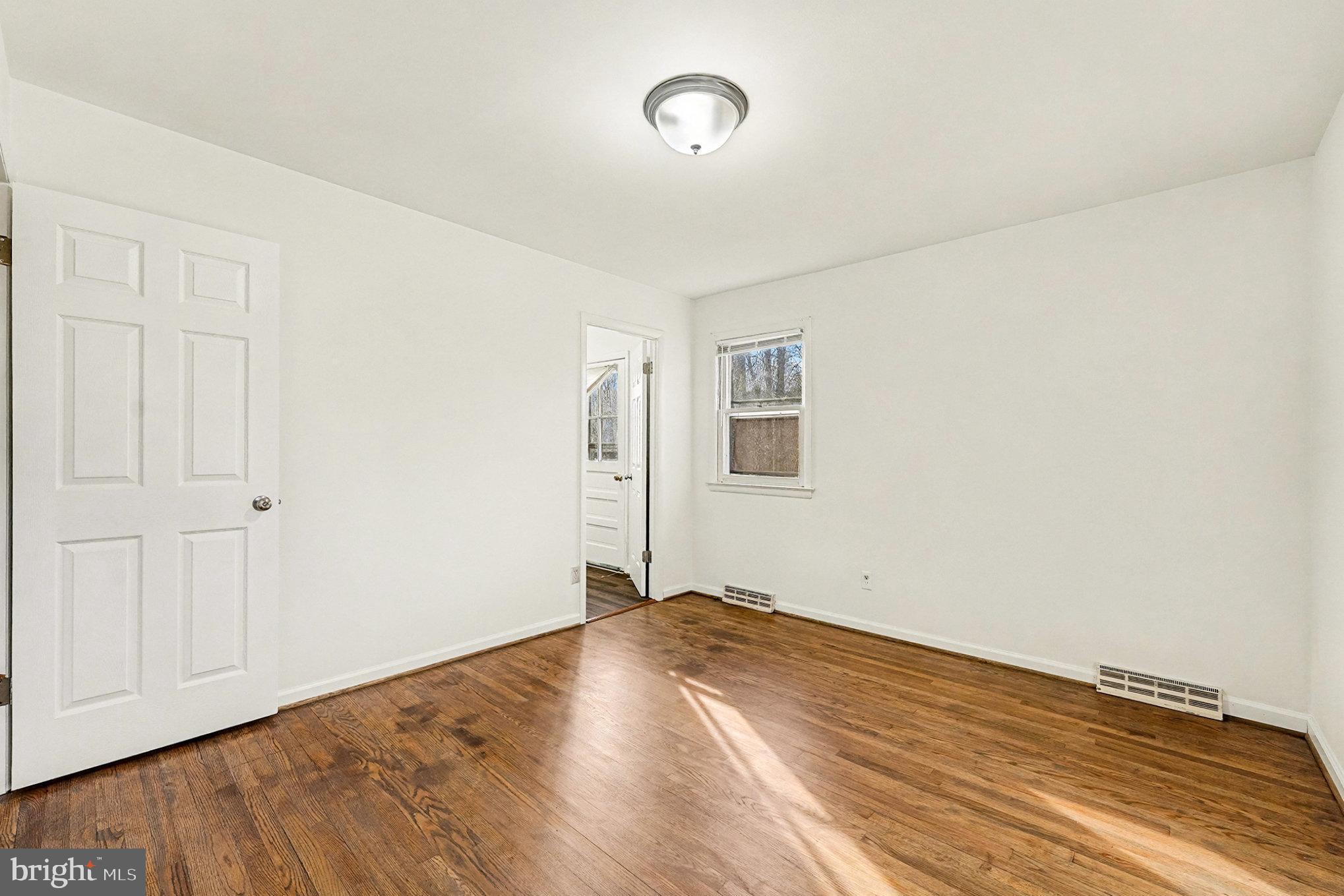 4127 Cabin Road Reva, VA 22735 - Photo 18 of 28 a view of empty room with wooden floor and fan