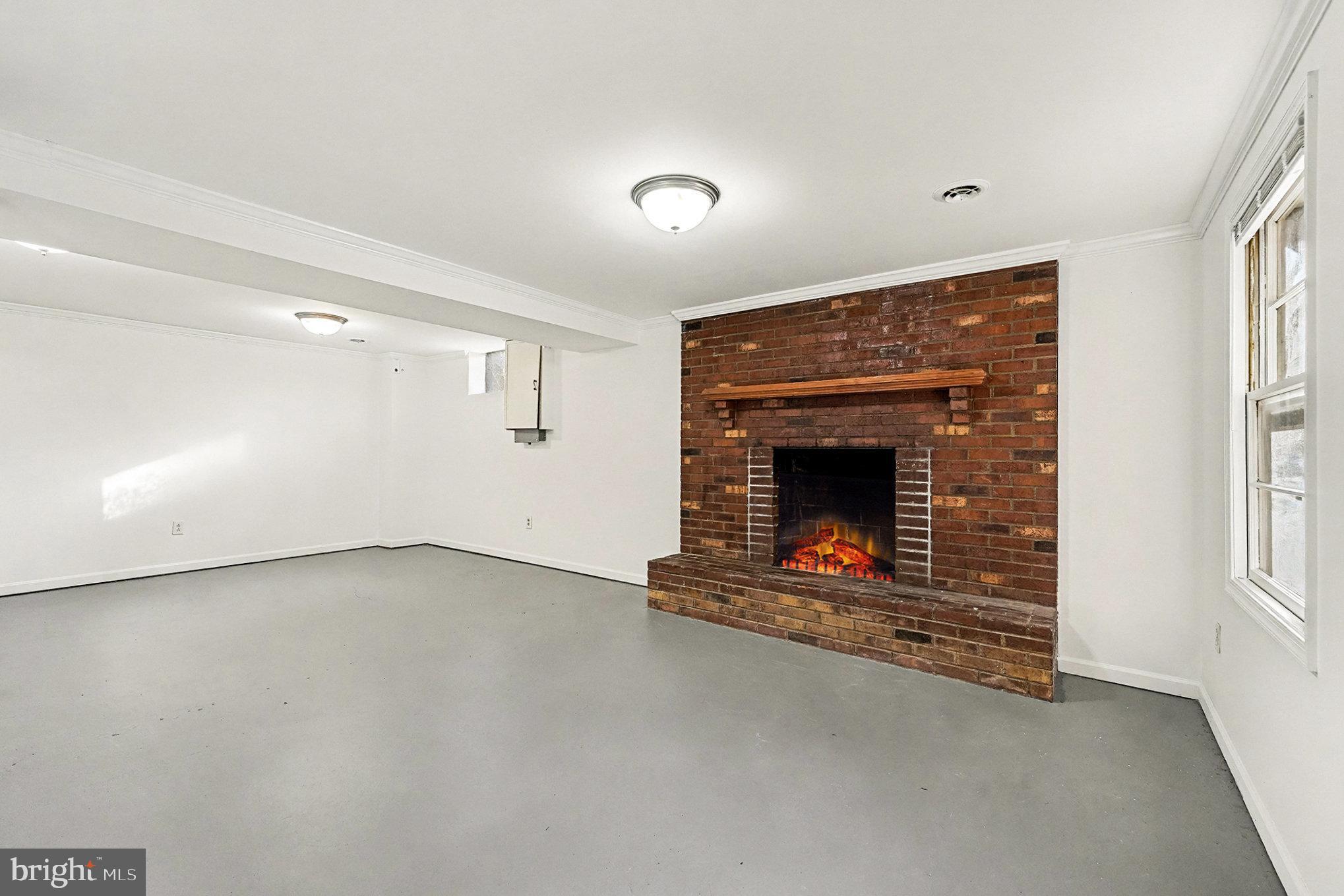 4127 Cabin Road Reva, VA 22735 - Photo 19 of 28 a view of an empty room with a fireplace and a window