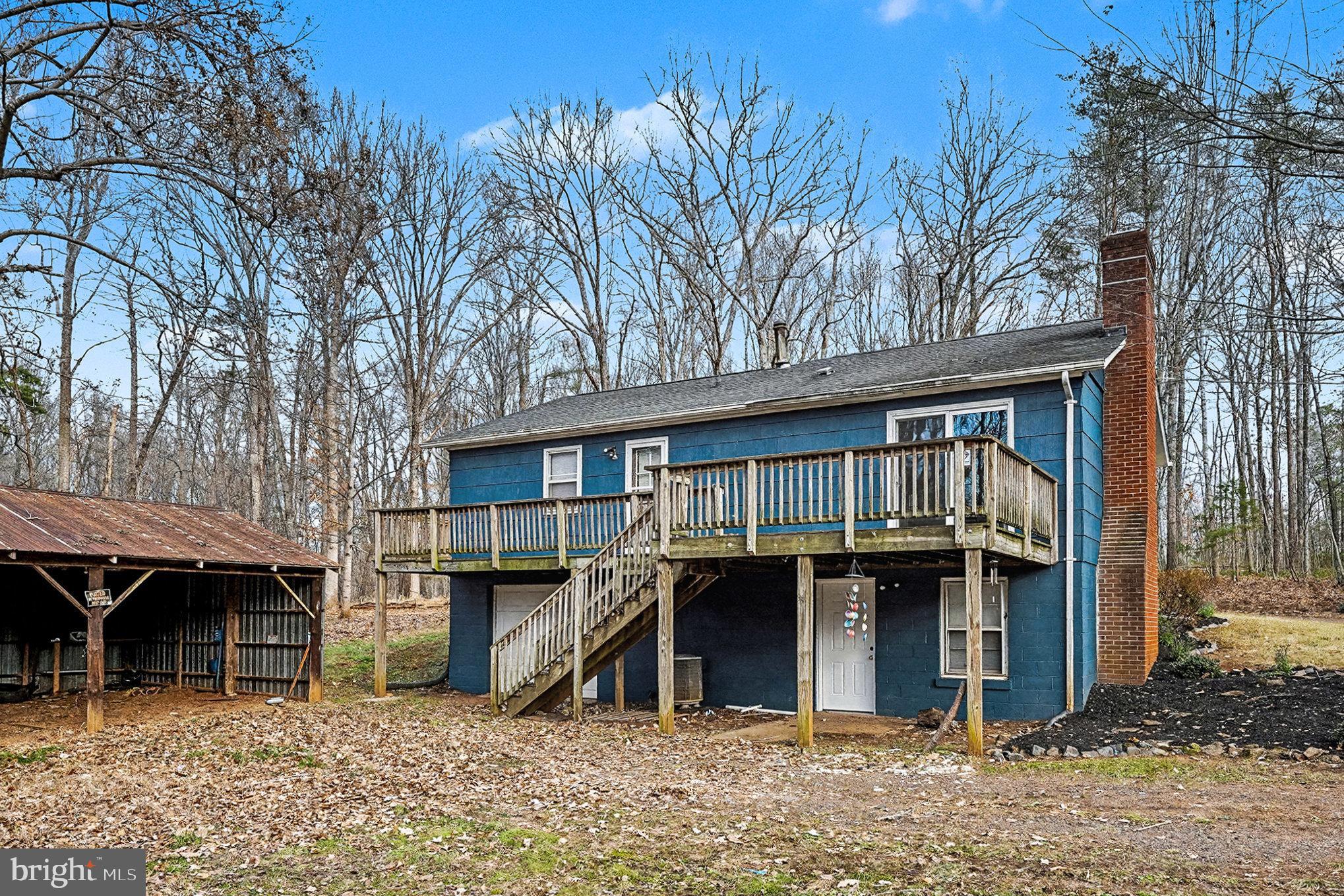 4127 Cabin Road Reva, VA 22735 - Photo 4 of 28 a view of a house with a large tree and wooden fence